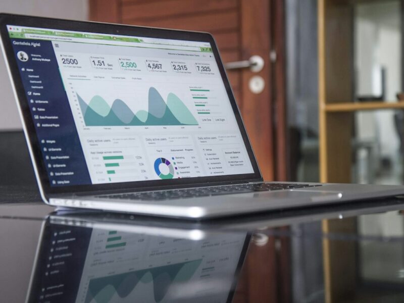Laptop displaying business charts and financial analysis
