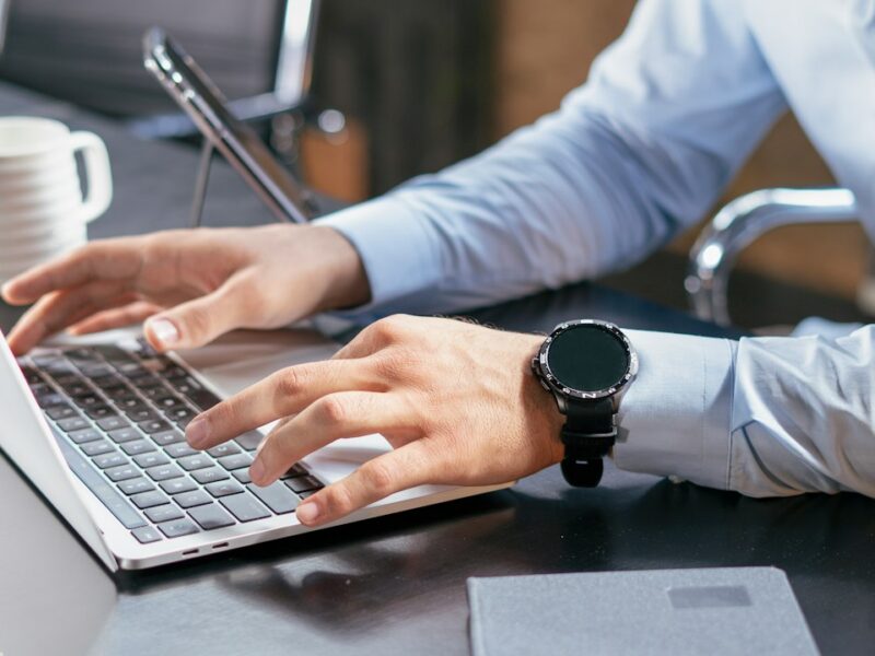 Business professional reviewing records on a laptop