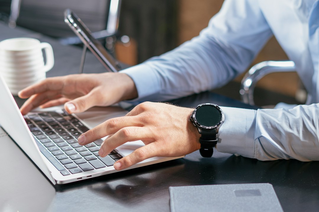 Business professional reviewing records on a laptop