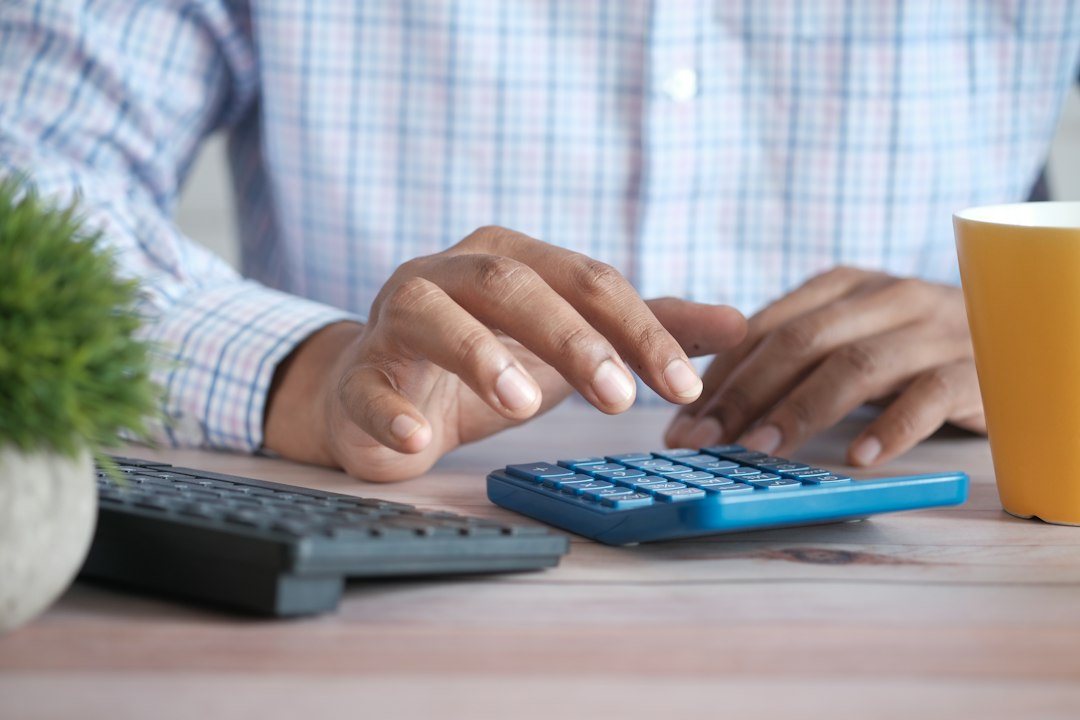 Professional reviewing financial paperwork with a calculator