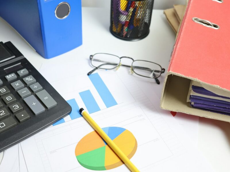 Organized financial reports and calculator on a professional office desk